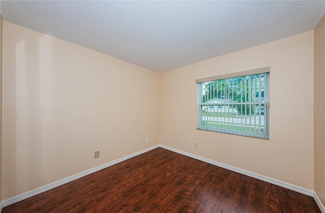 10051 82nd Ln, Seminole, FL 33777 - spare room featuring dark wood-style flooring and baseboards
