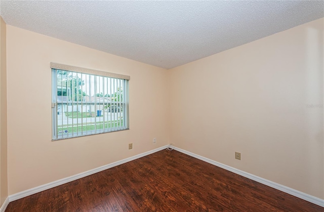 10051 82nd Ln, Seminole, FL 33777 - spare room with dark wood-style flooring, baseboards, and a textured ceiling