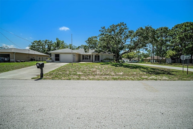 3305 Blythe Ave, Spring Hill, FL 34609 - ranch-style home with driveway, an attached garage, and a front yard