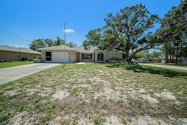 3305 Blythe Ave, Spring Hill, FL 34609 - ranch-style house with an attached garage, concrete driveway, and stucco siding