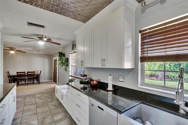 1716 Bayou Cir, Lakeland, FL 33803 - kitchen with dishwashing machine, plenty of natural light, a sink, and white cabinetry