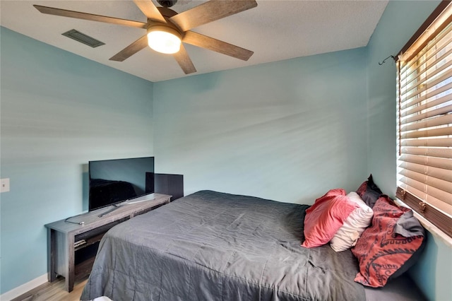 1716 Bayou Cir, Lakeland, FL 33803 - bedroom with light wood-style floors, a ceiling fan, and baseboards