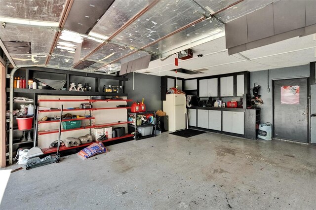 1716 Bayou Cir, Lakeland, FL 33803 - garage featuring freestanding refrigerator and a garage door opener