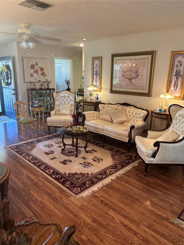 9302 Trowbridge Ct, New Port Richey, FL 34655 - living room with wood finished floors, ceiling fan, and a textured ceiling
