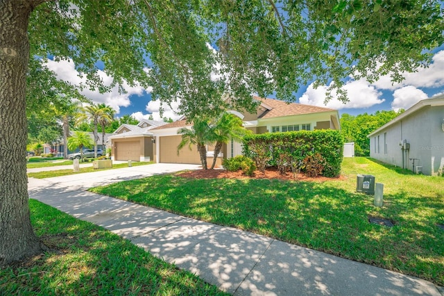 19247 Otters Wick Way, Land O Lakes, FL 34638 - view of front of house featuring a front yard, concrete driveway, a garage, and stucco siding