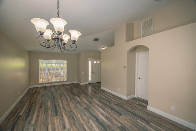 19247 Otters Wick Way, Land O Lakes, FL 34638 - empty room with a chandelier, dark wood finished floors, baseboards, arched walkways, and a textured ceiling