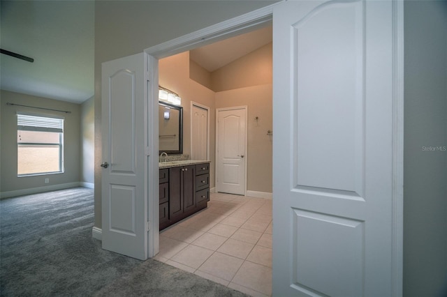 19247 Otters Wick Way, Land O Lakes, FL 34638 - bathroom featuring baseboards, vanity, lofted ceiling, and tile patterned flooring