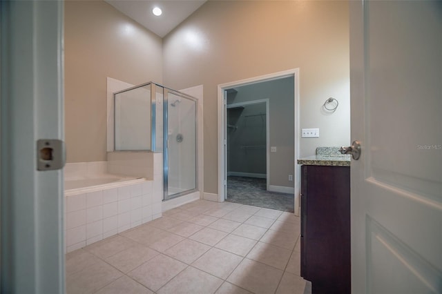 19247 Otters Wick Way, Land O Lakes, FL 34638 - bathroom featuring tile patterned flooring, a stall shower, a garden tub, vanity, and a walk in closet