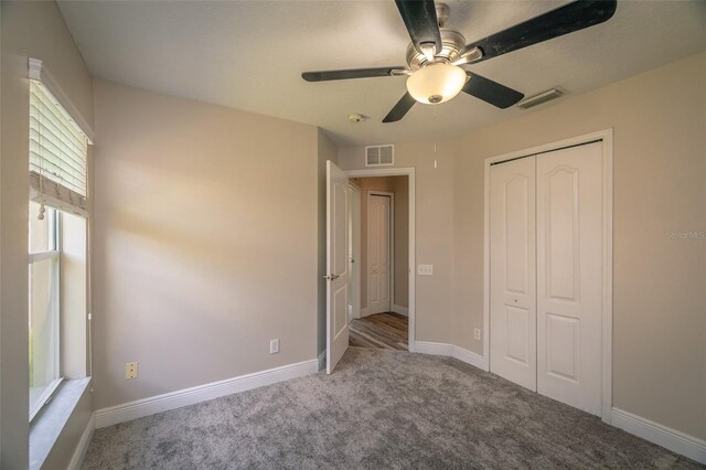 19247 Otters Wick Way, Land O Lakes, FL 34638 - unfurnished bedroom featuring carpet, a closet, baseboards, and ceiling fan