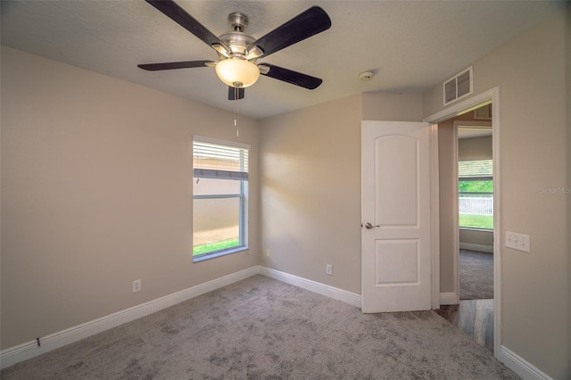 19247 Otters Wick Way, Land O Lakes, FL 34638 - unfurnished room featuring carpet, plenty of natural light, baseboards, and ceiling fan