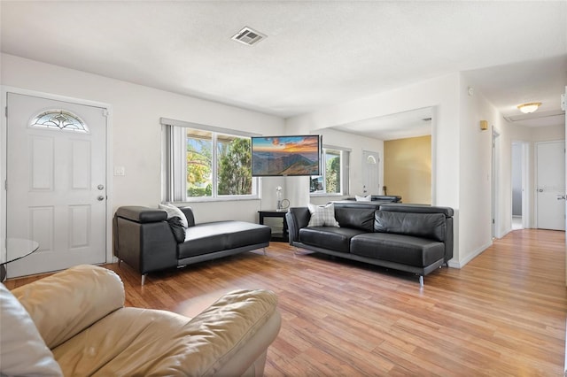 2048 64th Ave S, Saint Petersburg, FL 33712 - living room featuring light wood finished floors and baseboards