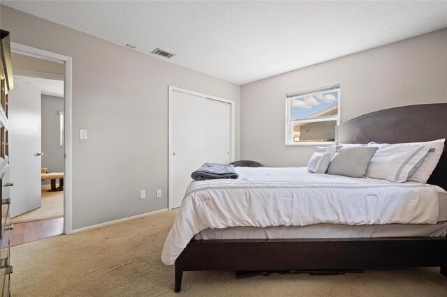 2048 64th Ave S, Saint Petersburg, FL 33712 - bedroom featuring light colored carpet, baseboards, and a closet