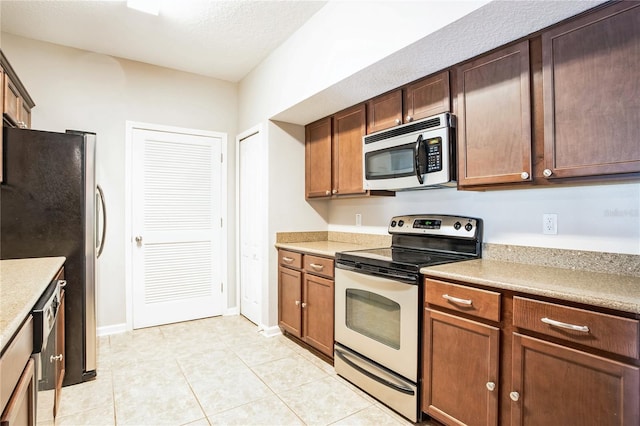 4991 Key Lime Dr Unit 104, Jacksonville, FL 32256 - kitchen with appliances with stainless steel finishes, light countertops, and light tile patterned flooring