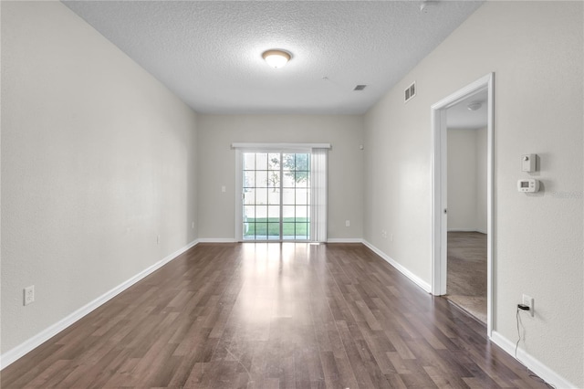 4991 Key Lime Dr Unit 104, Jacksonville, FL 32256 - unfurnished room featuring dark wood-type flooring, a textured ceiling, and baseboards