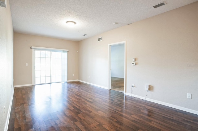 4991 Key Lime Dr Unit 104, Jacksonville, FL 32256 - spare room featuring dark wood finished floors, a textured ceiling, and baseboards