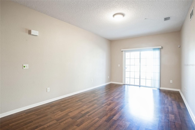 4991 Key Lime Dr Unit 104, Jacksonville, FL 32256 - unfurnished room with dark wood-type flooring, baseboards, and a textured ceiling