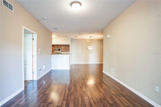 4991 Key Lime Dr Unit 104, Jacksonville, FL 32256 - unfurnished living room featuring dark wood finished floors, a textured ceiling, and baseboards