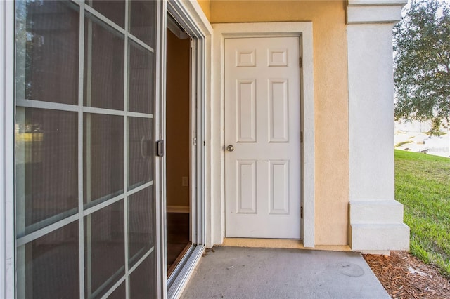 4991 Key Lime Dr Unit 104, Jacksonville, FL 32256 - doorway to property with stucco siding
