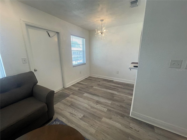 2011 58th Ave N Unit 20, Saint Petersburg, FL 33714 - sitting room with a chandelier, wood finished floors, and baseboards