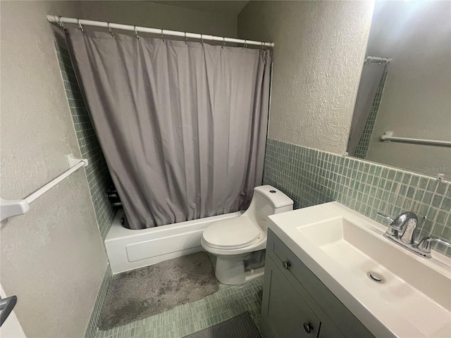 2011 58th Ave N Unit 20, Saint Petersburg, FL 33714 - full bathroom with tile walls, shower / bath combo, toilet, a textured wall, and vanity