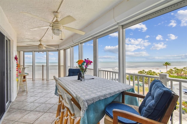 17980 Gulf Blvd Unit 505, Redington Shores, FL 33708 - sunroom / solarium featuring view of water and beach, a textured ceiling, and stone finish floors