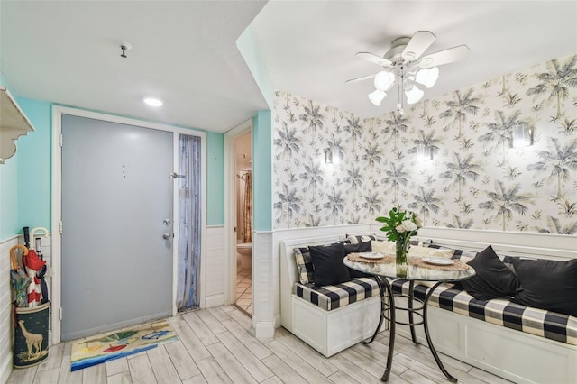 17980 Gulf Blvd Unit 505, Redington Shores, FL 33708 - dining room with wallpapered walls, wood finish floors, a wainscoted wall, ceiling fan, and breakfast area