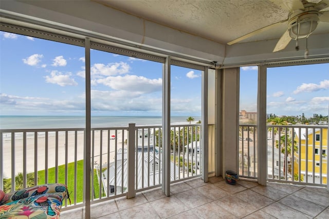 17980 Gulf Blvd Unit 505, Redington Shores, FL 33708 - unfurnished sunroom featuring view of water and beach and tile patterned floors