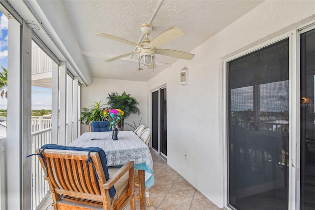 17980 Gulf Blvd Unit 505, Redington Shores, FL 33708 - sunroom featuring ceiling fan, a textured ceiling, and tile patterned floors