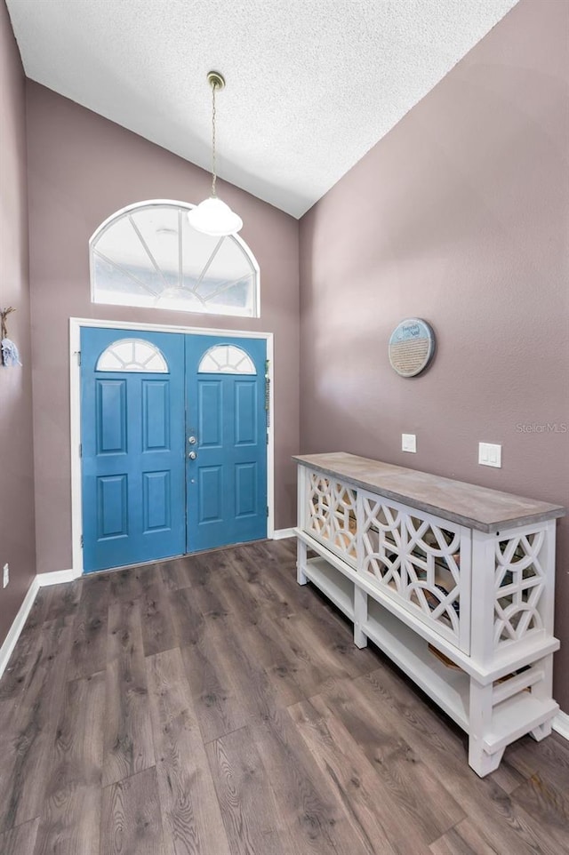 6521 Oelsner St, New Port Richey, FL 34652 - entrance foyer featuring a textured ceiling, wood finished floors, and baseboards