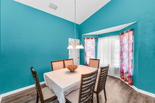 6521 Oelsner St, New Port Richey, FL 34652 - dining space with wood finished floors, baseboards, and high vaulted ceiling