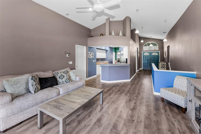6521 Oelsner St, New Port Richey, FL 34652 - living room with high vaulted ceiling, a ceiling fan, wood finished floors, and baseboards