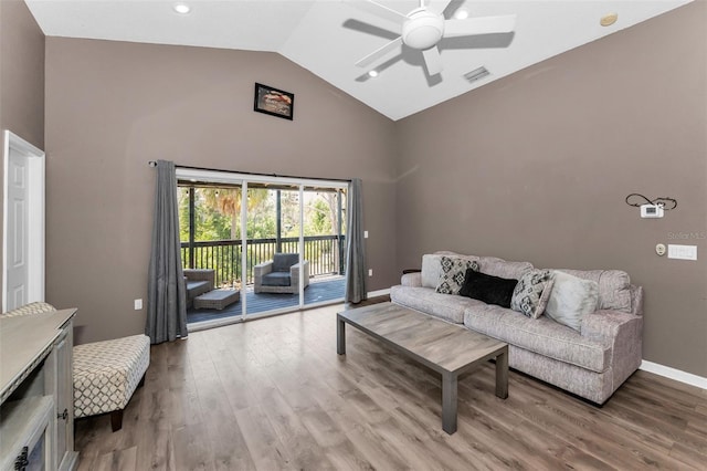6521 Oelsner St, New Port Richey, FL 34652 - living room featuring a ceiling fan, wood finished floors, high vaulted ceiling, and baseboards