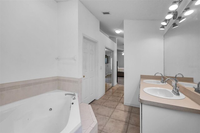 6521 Oelsner St, New Port Richey, FL 34652 - ensuite bathroom with a whirlpool tub, double vanity, and tile patterned flooring