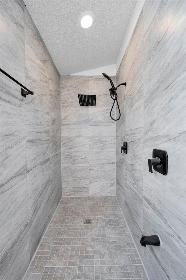6521 Oelsner St, New Port Richey, FL 34652 - full bath with a textured ceiling and a tile shower