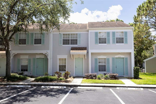 8545 Hunters Key Cir, Tampa, FL 33647 - townhome / multi-family property with stucco siding, uncovered parking, and a shingled roof