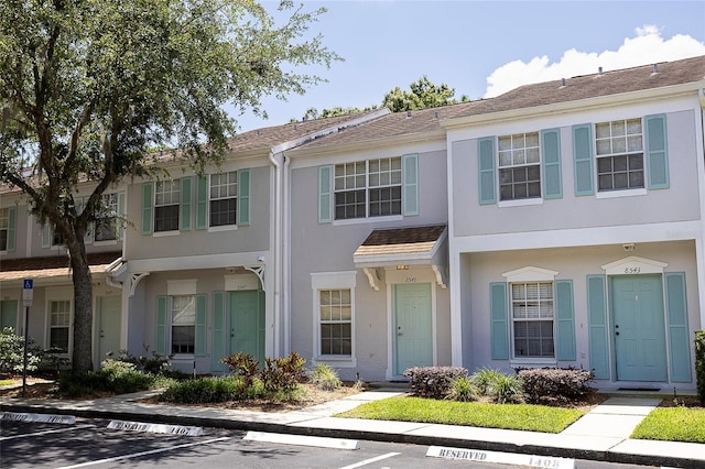 8545 Hunters Key Cir, Tampa, FL 33647 - view of property featuring uncovered parking and stucco siding