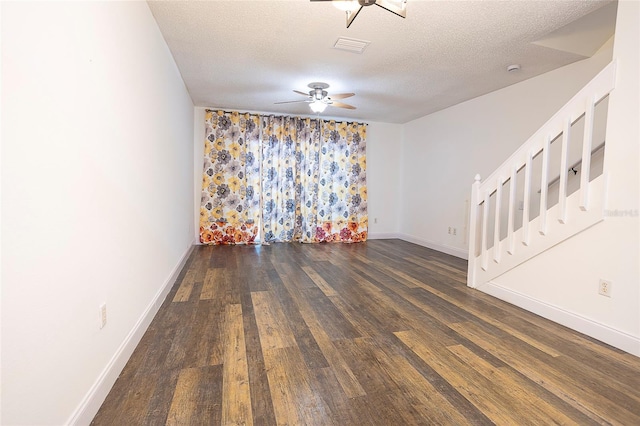 8545 Hunters Key Cir, Tampa, FL 33647 - spare room with wood finished floors, a ceiling fan, a textured ceiling, baseboards, and stairway