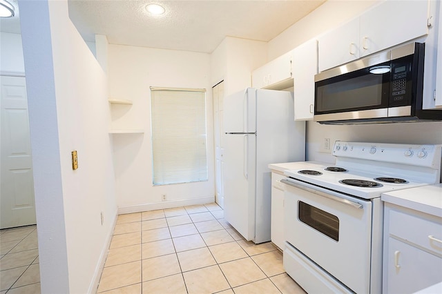 8545 Hunters Key Cir, Tampa, FL 33647 - kitchen featuring white appliances, light tile patterned floors, light countertops, white cabinets, and recessed lighting