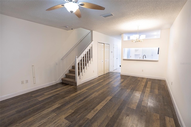 8545 Hunters Key Cir, Tampa, FL 33647 - unfurnished living room with stairs, a chandelier, wood finished floors, ceiling fan, and a textured ceiling