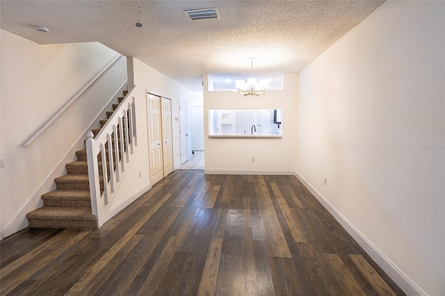 8545 Hunters Key Cir, Tampa, FL 33647 - entrance foyer with stairs, a chandelier, dark wood finished floors, a textured ceiling, and baseboards
