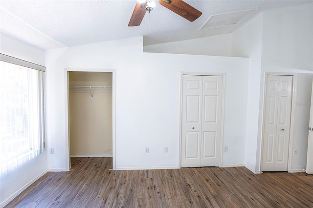 8545 Hunters Key Cir, Tampa, FL 33647 - unfurnished bedroom featuring multiple windows, wood finished floors, two closets, lofted ceiling, and baseboards