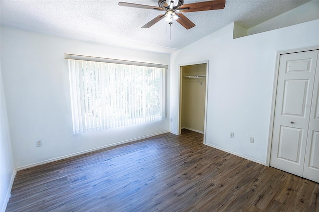 8545 Hunters Key Cir, Tampa, FL 33647 - unfurnished bedroom with lofted ceiling, wood finished floors, a textured ceiling, baseboards, and ceiling fan