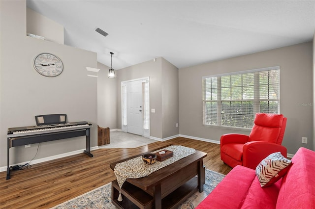 25332 Lexington Oaks Blvd, Wesley Chapel, FL 33544 - living area featuring vaulted ceiling, wood finished floors, and baseboards