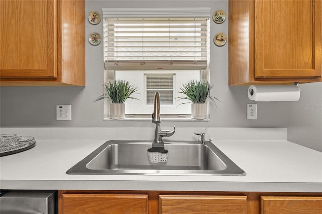 25332 Lexington Oaks Blvd, Wesley Chapel, FL 33544 - kitchen with a sink, brown cabinetry, and light countertops