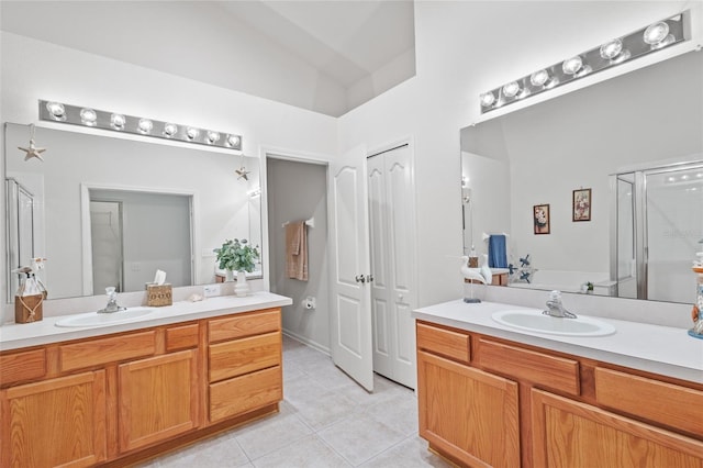 25332 Lexington Oaks Blvd, Wesley Chapel, FL 33544 - full bath with tile patterned floors, a shower stall, two vanities, a garden tub, and lofted ceiling
