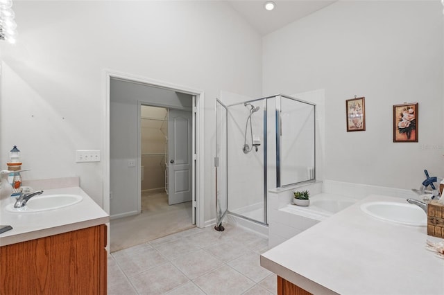 25332 Lexington Oaks Blvd, Wesley Chapel, FL 33544 - bathroom with a shower stall, tile patterned floors, two vanities, a high ceiling, and a bath