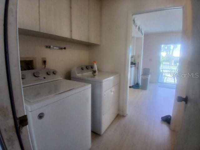 laundry room featuring washer and dryer and cabinet space
