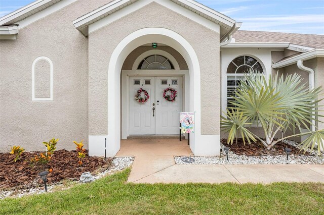 25942 Risen Star Dr, Wesley Chapel, FL 33544 - doorway to property with stucco siding