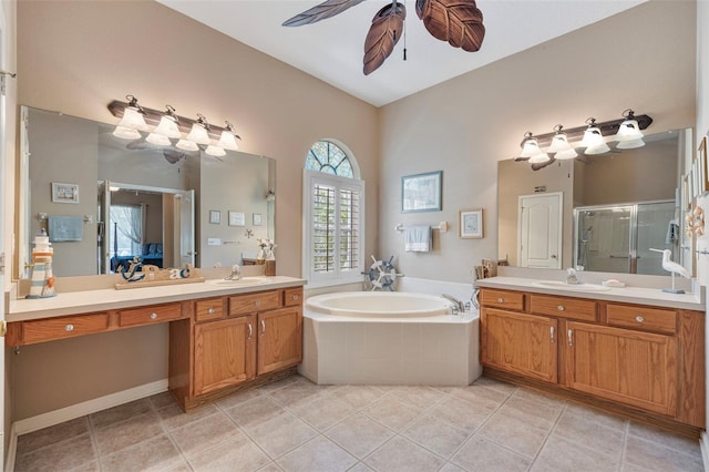 25942 Risen Star Dr, Wesley Chapel, FL 33544 - full bath with ceiling fan, a stall shower, two vanities, a bath, and tile patterned floors