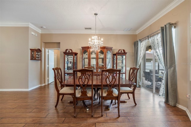 25942 Risen Star Dr, Wesley Chapel, FL 33544 - dining room with a chandelier, wood-type flooring, and crown molding